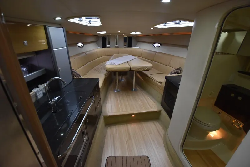 Slide: The Image of 2011 Formula 400ss yacht interior with kitchen, seating area, and bathroom. - 14