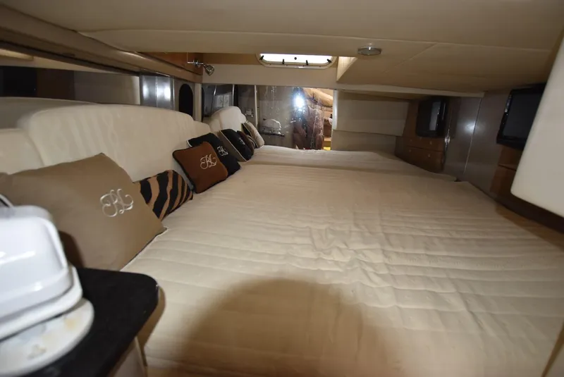 Slide: The Image of Interior cabin of a 2011 Formula 400ss boat with a spacious bed and decorative pillows. - 19