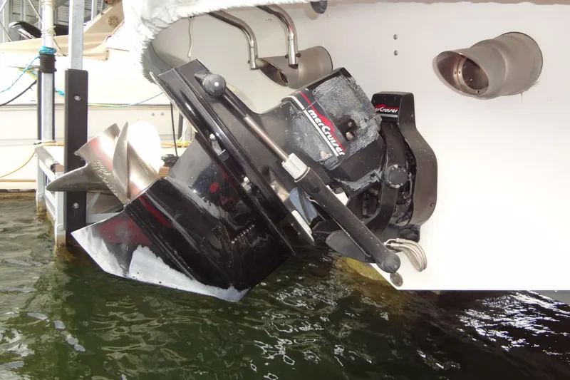 Slide: The Image of 1998 Wellcraft 26 Scarab boat with MerCruiser outboard motor in docked position. - 30