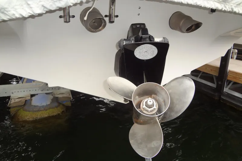 Slide: The Image of 1998 Wellcraft 26 Scarab boat propeller and stern view at dock. - 32