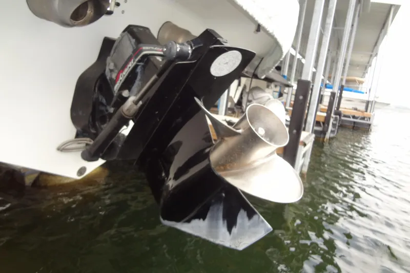 Slide: The Image of 1998 Wellcraft 26 Scarab boat propeller and outdrive in water at dock. - 33