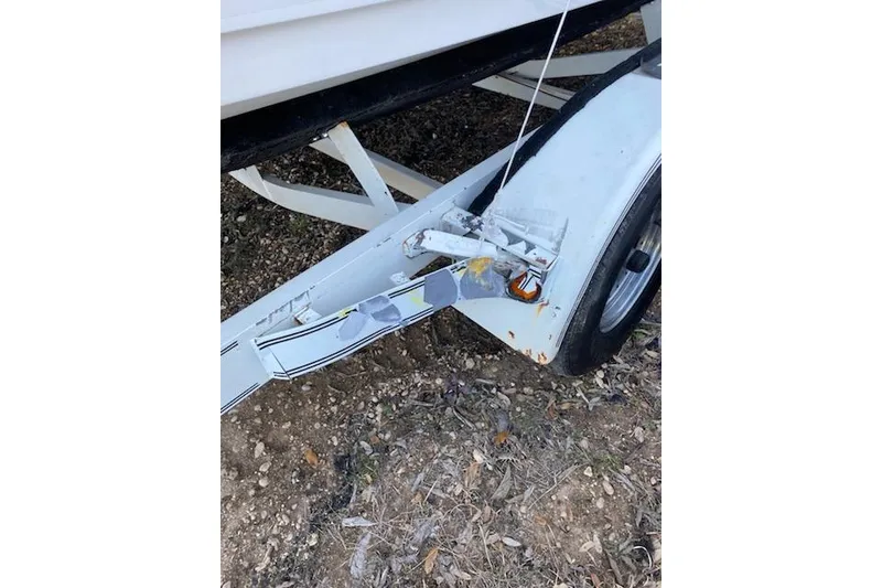 Slide: The Image of Trailer hitch of a 1998 Wellcraft 26 Scarab boat on rough terrain. - 34