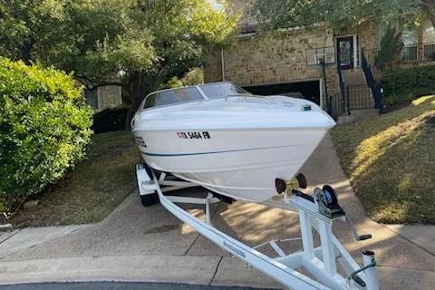 Slide: The Image of 1998 Wellcraft 26 Scarab boat on trailer in residential driveway. - 37