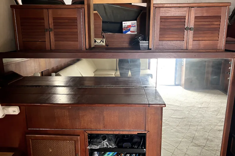 Slide: The Image of Interior of 1982 Viking 46 Convertible yacht with wooden cabinetry and mirrored wall. - 7