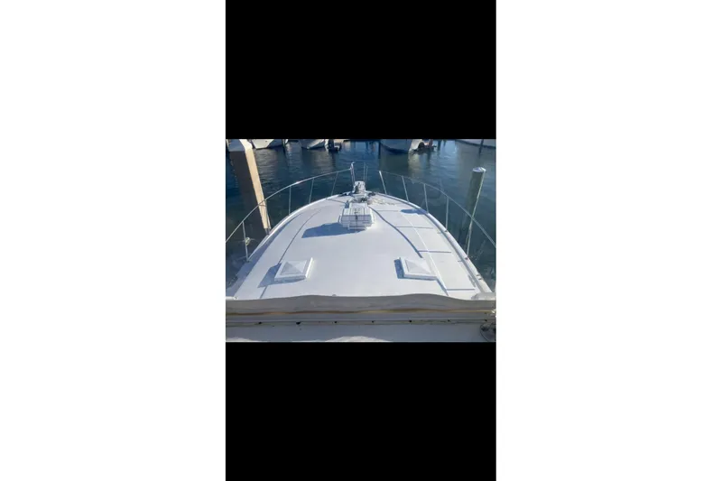 Slide: The Image of 1982 Viking 46 Convertible yacht bow view at marina. - 3