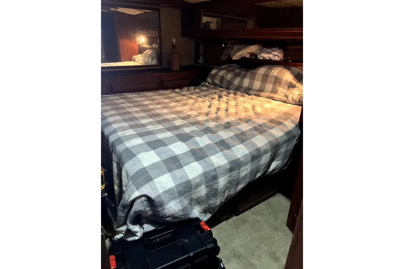 Slide: The Image of Cozy bedroom interior of 1982 Viking 46 Convertible yacht with plaid bedding. - 6