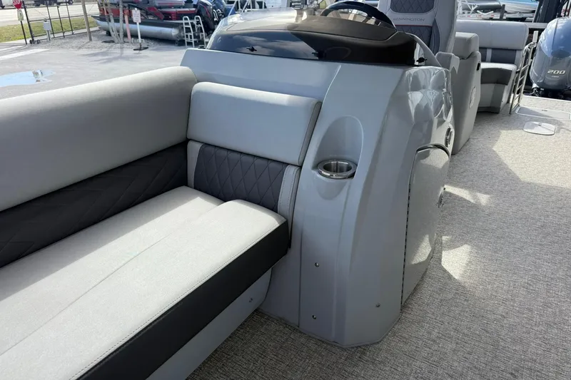 Slide: The Image of 2022 Bennington 25 LFB boat interior with gray seating and console. - 12