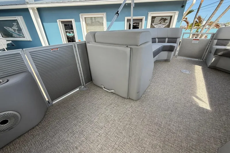 Slide: The Image of 2022 Bennington 25 LFB pontoon boat interior with gray seating and carpeted floor. - 14