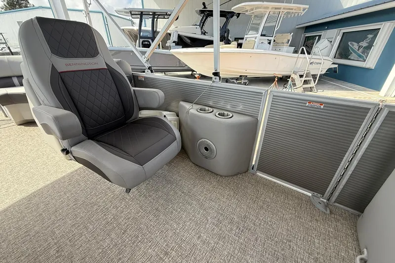 Slide: The Image of Luxurious seating on a 2022 Bennington 25 LFB pontoon boat, featuring cup holders and modern design. - 16