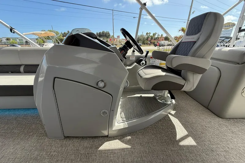 Slide: The Image of 2022 Bennington 25 LFB boat interior with captain's chair and steering console. - 19