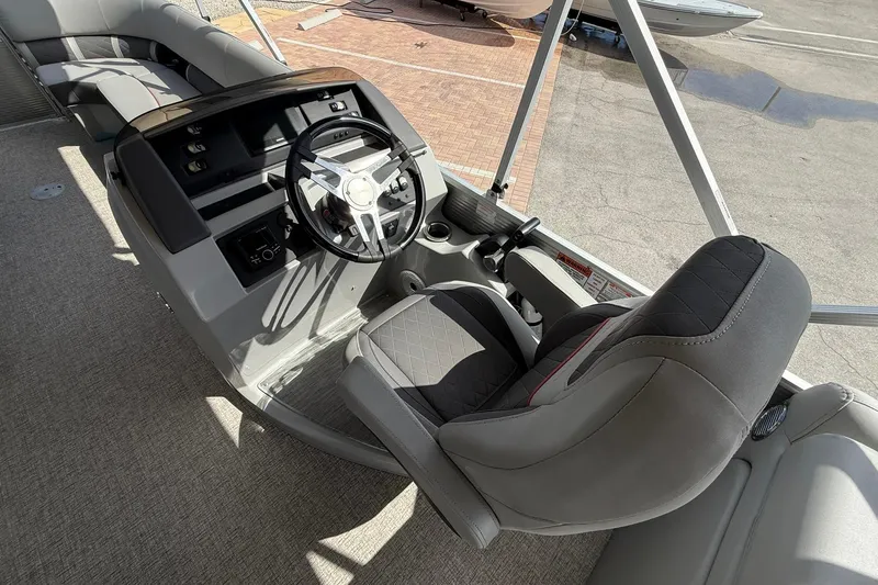 Slide: The Image of Interior view of 2022 Bennington 25 LFB boat, featuring steering wheel and seating. - 20