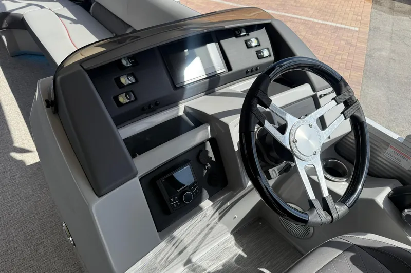 Slide: The Image of 2022 Bennington 25 LFB boat dashboard with steering wheel and control panel. - 21