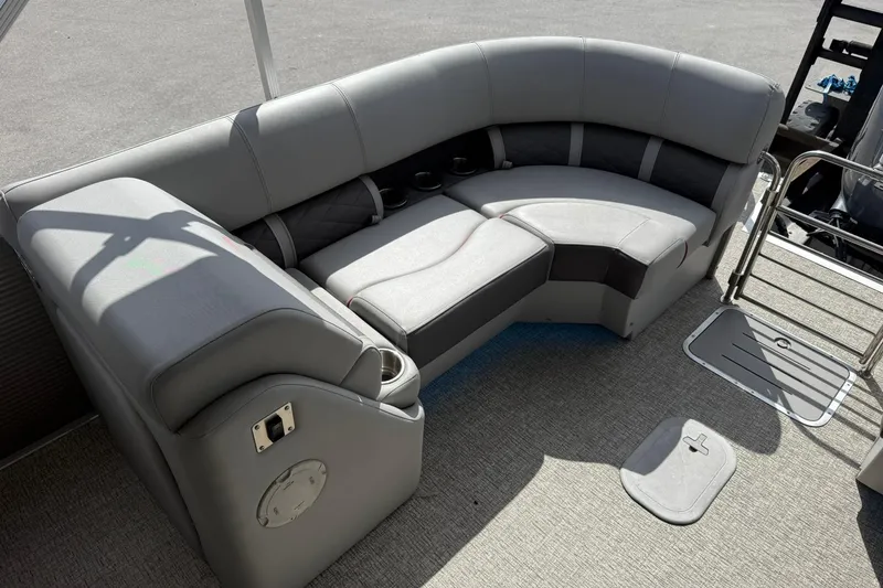 Slide: The Image of 2022 Bennington 25 LFB boat with gray seating and cup holders on deck. - 23