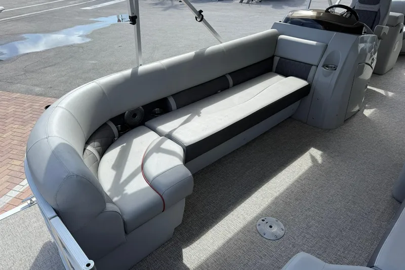 Slide: The Image of 2022 Bennington 25 LFB boat interior with gray seating and steering console. - 9