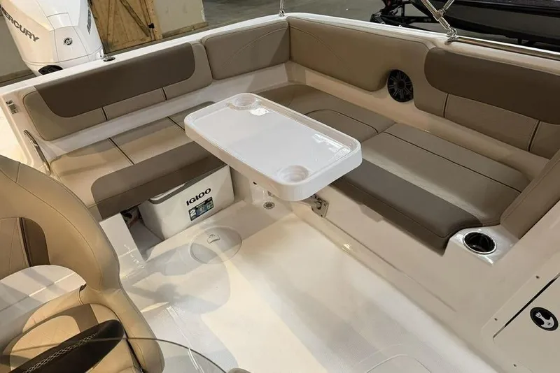 Slide: The Image of 2026 Tahoe 2150 boat interior with seating, table, and Igloo cooler. - 11