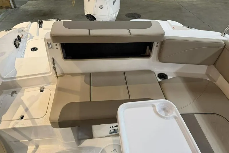 Slide: The Image of 2026 Tahoe 2150 boat interior with beige seating and white tray table. - 15