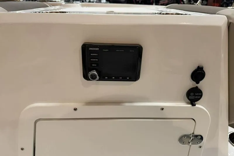 Slide: The Image of 2026 Tahoe 2150 boat dashboard with audio controls and storage compartment. - 16