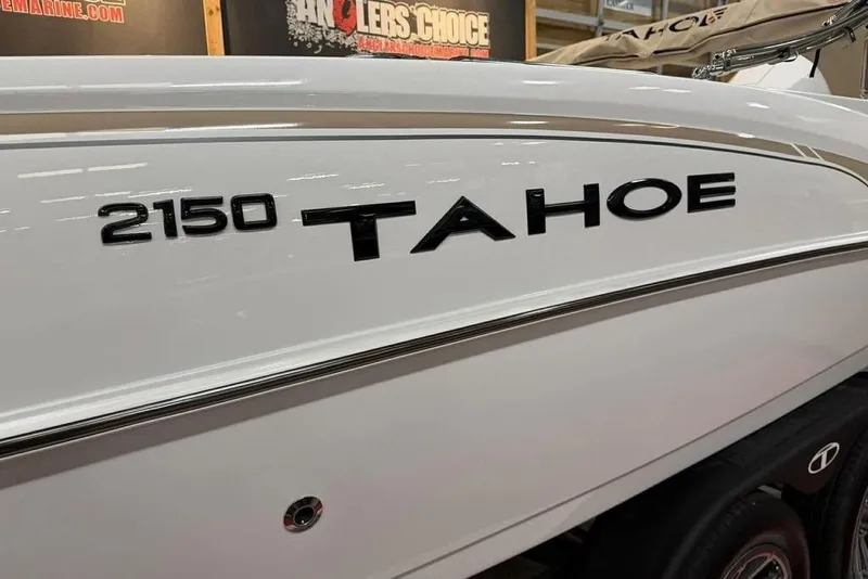 Slide: The Image of 2026 Tahoe 2150 boat side view with logo in showroom setting. - 17