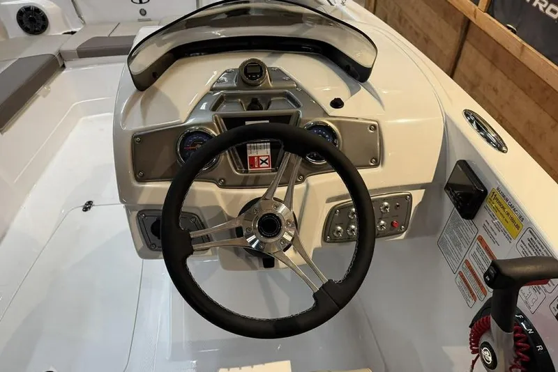 Slide: The Image of 2026 Tahoe 2150 boat dashboard with steering wheel and control panel. - 3