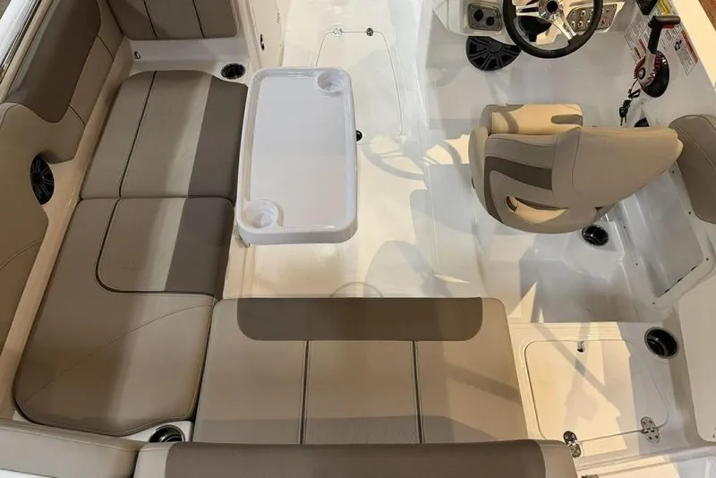 Slide: The Image of Interior of 2026 Tahoe 2150 boat with beige seating and white table. - 9