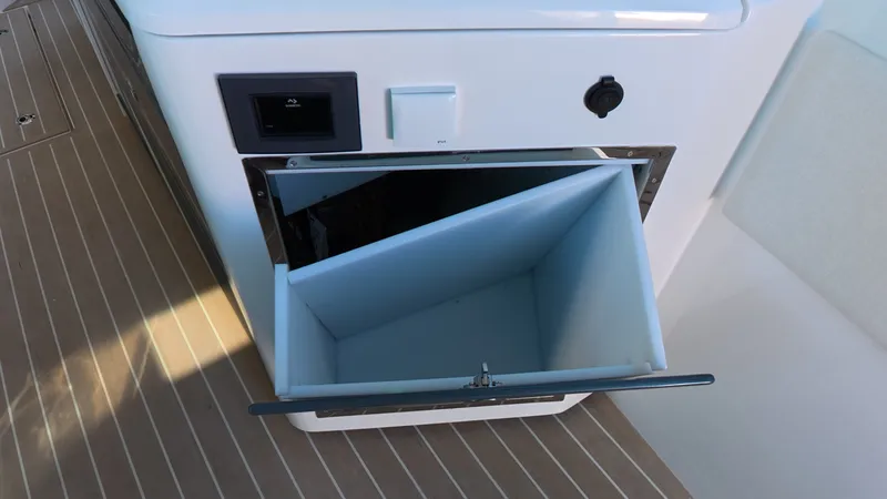 Slide: The Image of Open storage compartment on the Saxdor 400 GTC deck, featuring wooden flooring. - 27