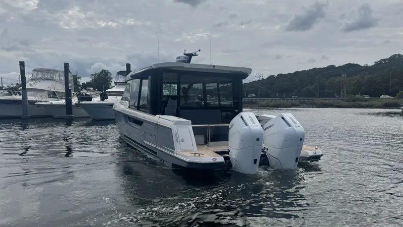 Slide: The Image of The image shows a 2027 Saxdor 400 GTC boat with twin outboard engines on the water. - 4