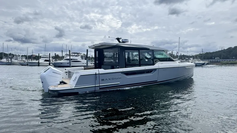 Slide: The Image of A 2027 Saxdor 400 GTC is on the water. It features a modern design with large windows. - 2