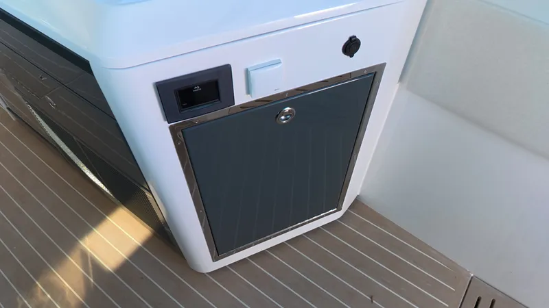 Slide: The Image of A modern kitchen appliance with a gray door and stainless steel frame on a boat. - 26