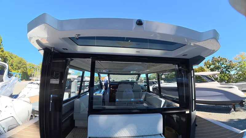 Slide: The Image of The image shows the rear of a Saxdor 400 GTC boat with a modern, glass-enclosed structure. - 12