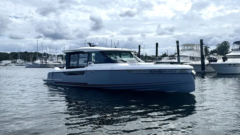 Slide: The Image of A 2027 Saxdor 400 GTC is on the water, surrounded by other boats in the harbor. - 1