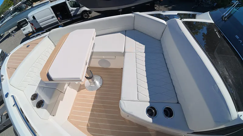 Slide: The Image of The image shows the deck of a 2027 Saxdor 400 GTC with white cushioned seating and a table. - 41