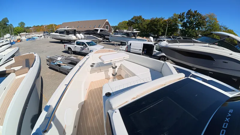 Slide: The Image of The image shows a Saxdor 400 GTC boat in a parking area with other boats and vehicles. - 39