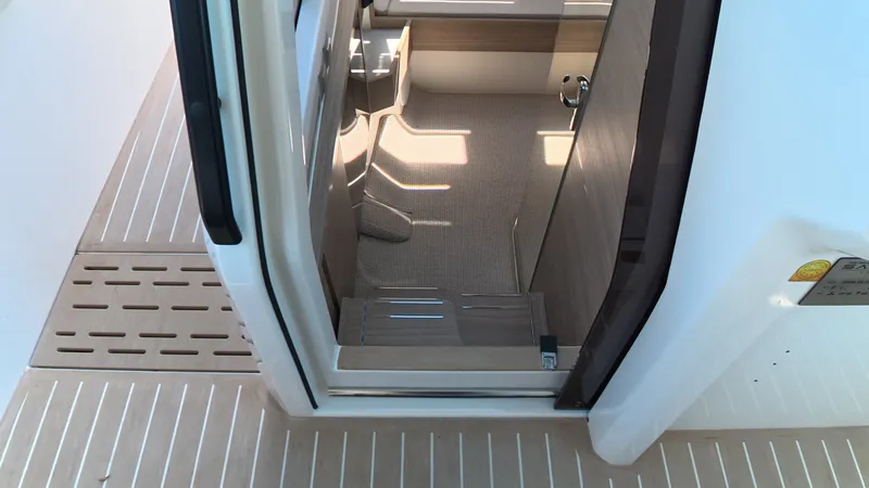 Slide: The Image of View of a modern boat entrance with carpeted flooring and wood accents. - 28