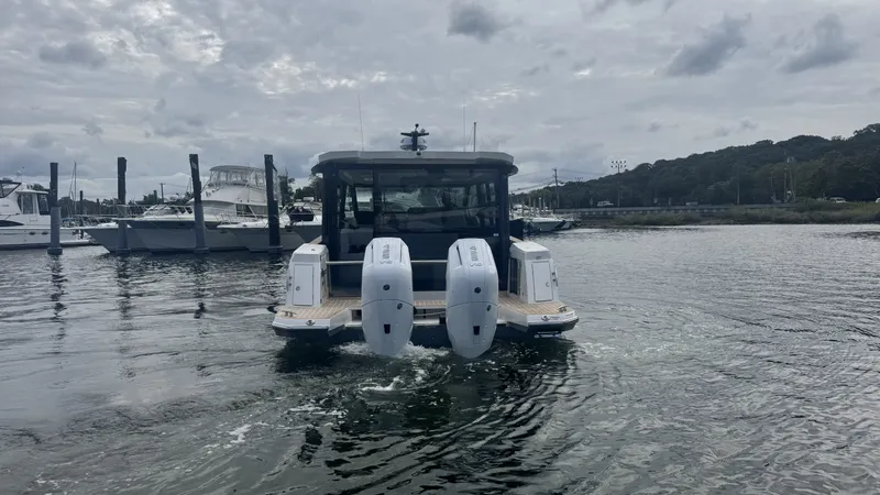 Slide: The Image of The 2027 Saxdor 400 GTC is on calm waters, featuring three outboard engines. - 3