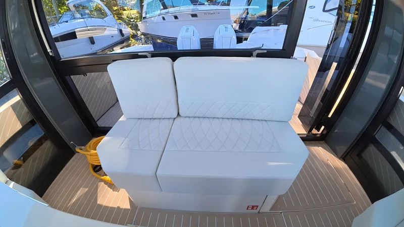 Slide: The Image of The 2027 Saxdor 400 GTC features a sleek white bench seat in a modern interior. - 14
