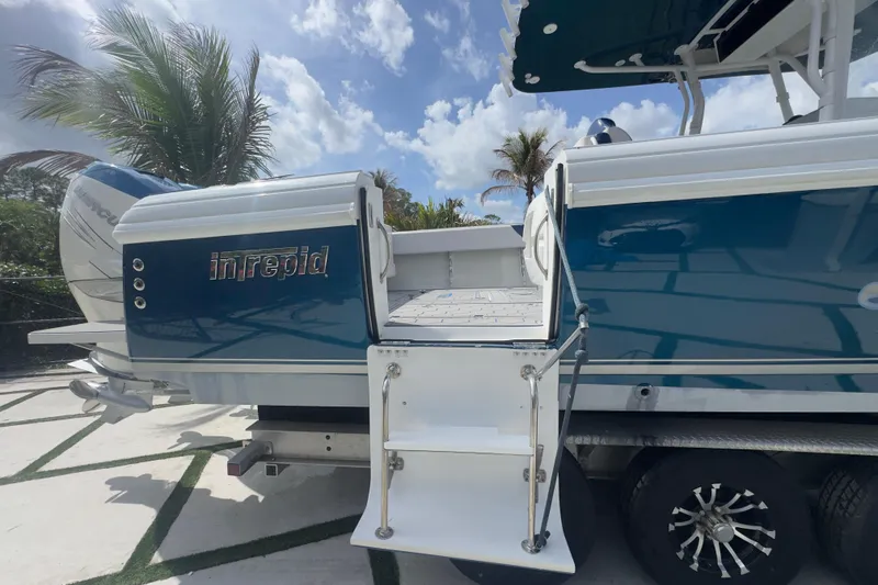 Slide: The Image of 2007 Intrepid 370 Center Console boat with blue hull and rear entry ladder. - 10