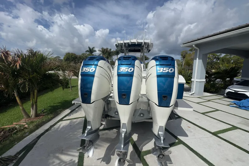 Slide: The Image of 2007 Intrepid 370 Center Console with triple 350 horsepower engines, parked outdoors. - 14