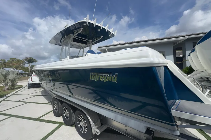 Slide: The Image of 2007 Intrepid 370 Center Console boat on trailer, parked outdoors under a cloudy sky. - 19
