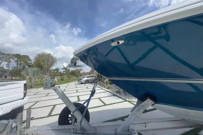 Slide: The Image of 2007 Intrepid 370 Center Console boat on trailer, parked outdoors under a cloudy sky. - 23