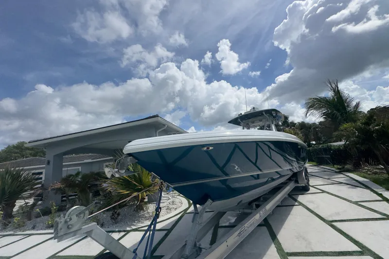 Slide: The Image of 2007 Intrepid 370 Center Console boat on trailer under cloudy sky. - 24
