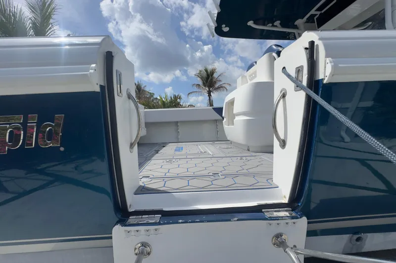 Slide: The Image of 2007 Intrepid 370 Center Console boat with open deck, blue skies, and palm trees. - 31