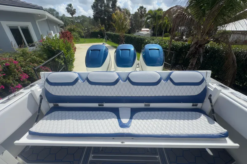 Slide: The Image of 2007 Intrepid 370 Center Console boat with blue and white seating and triple engines. - 34