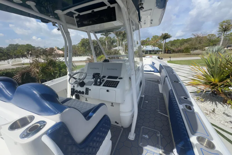 Slide: The Image of 2007 Intrepid 370 Center Console boat interior with blue seating and Garmin navigation. - 36
