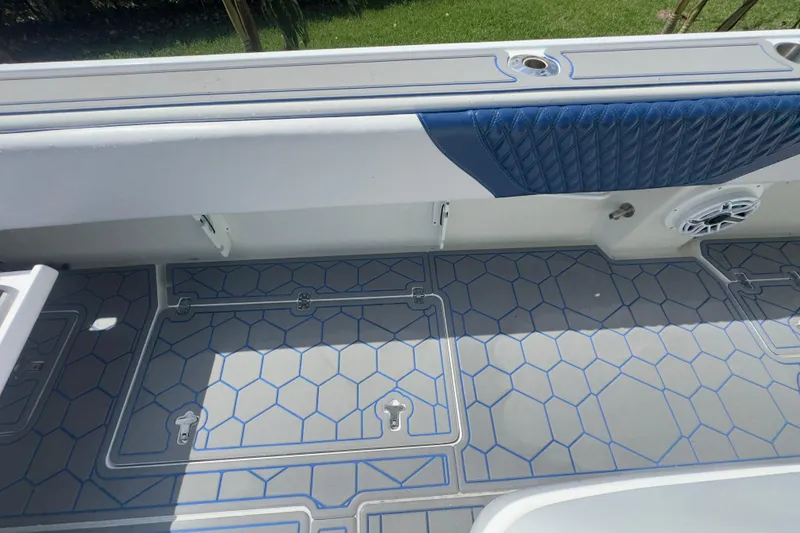 Slide: The Image of 2007 Intrepid 370 Center Console boat deck with blue accents and hexagonal pattern. - 38