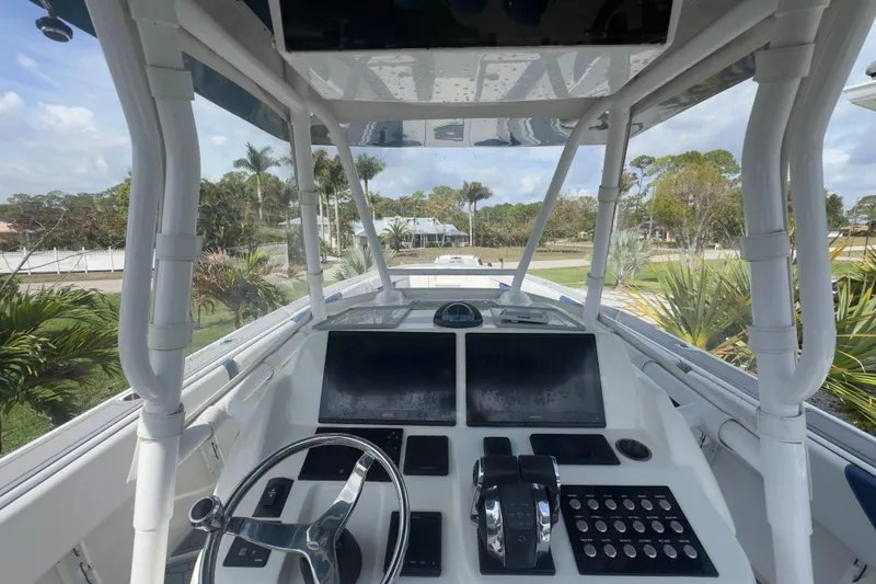 Slide: The Image of 2007 Intrepid 370 Center Console helm with dual screens and steering wheel. - 40