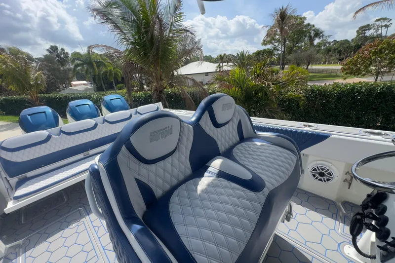 Slide: The Image of 2007 Intrepid 370 Center Console boat with luxurious seating and scenic background. - 41