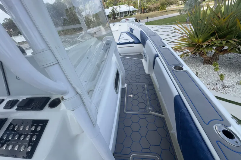 Slide: The Image of 2007 Intrepid 370 Center Console boat interior with blue seating and hexagonal flooring. - 42