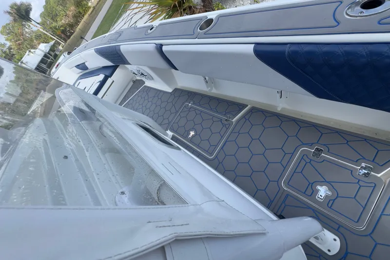 Slide: The Image of 2007 Intrepid 370 Center Console boat interior with blue and gray seating and flooring. - 43