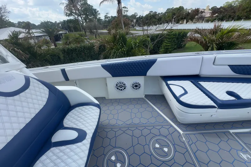 Slide: The Image of 2007 Intrepid 370 Center Console boat interior with blue and white seating and hexagonal flooring. - 45