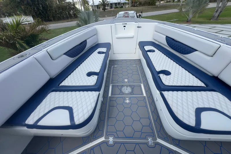 Slide: The Image of 2007 Intrepid 370 Center Console boat interior with blue and white seating and geometric flooring. - 46